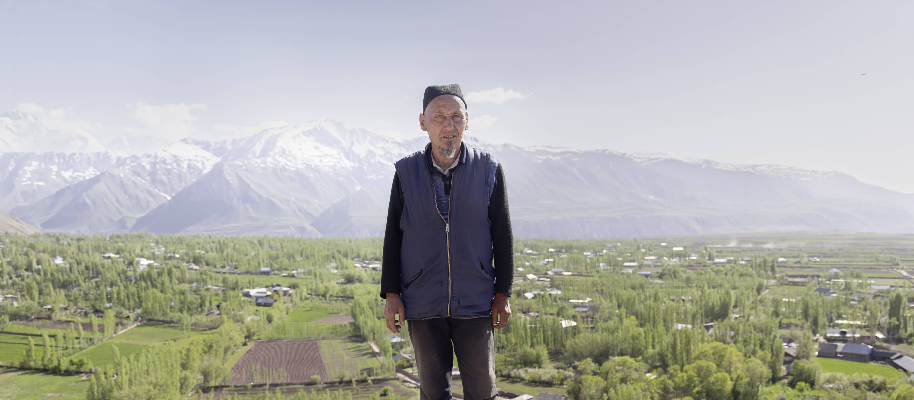 Shokirjon Shamirov on a hill in front of his home in Shirinob in Tajikistan.