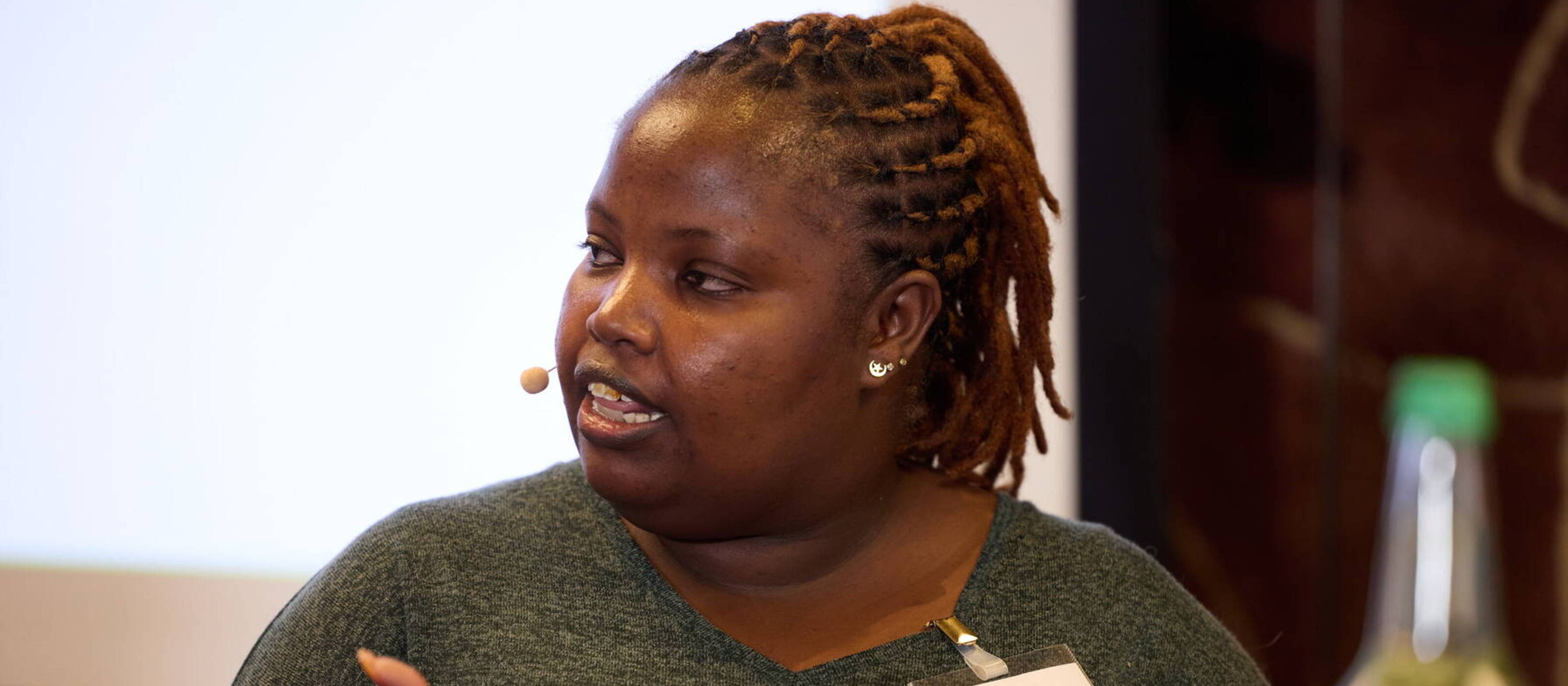 Winnie Cheche on the podium at the Caritas Symposium 2024.