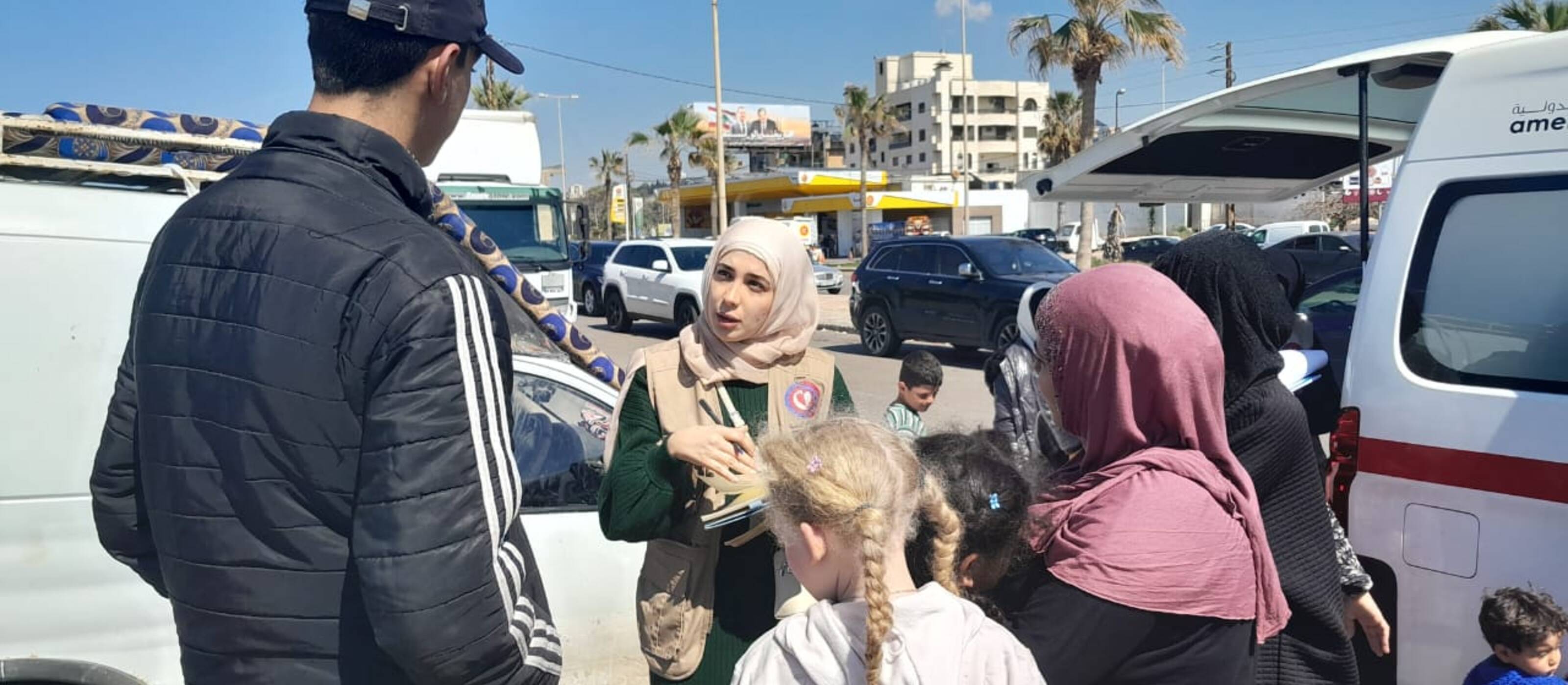 Staff members talking with people who were forced to flee South Sudan.