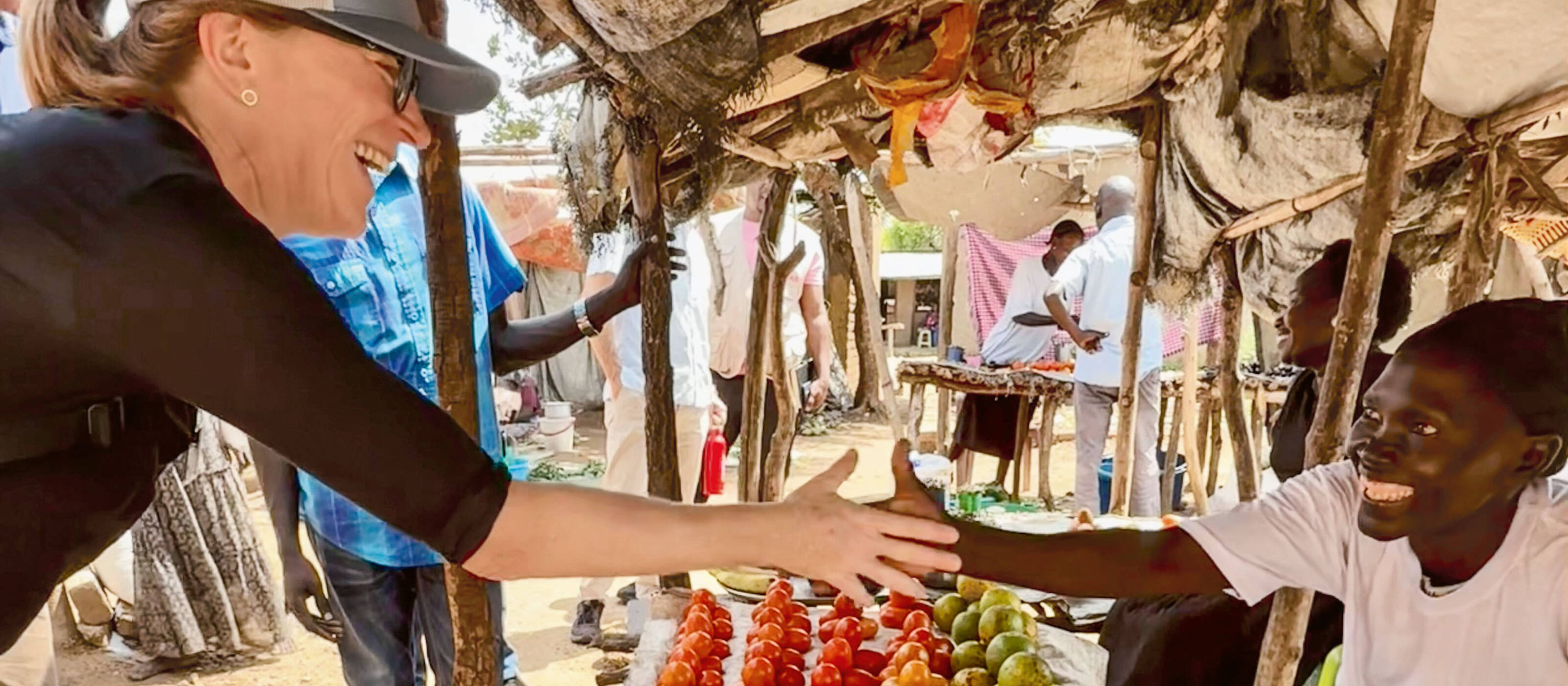 Donner aux gens les moyens d’assurer eux-mêmes leur existence: c’est l’objectif de Martina Weber, ici en conversation avec une vendeuse en Ouganda.