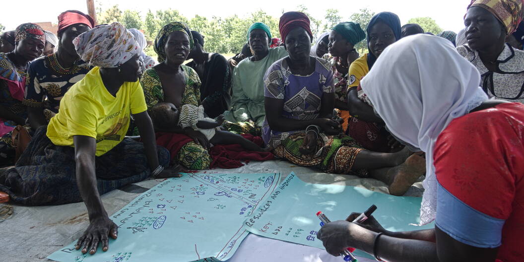 Project participants in a refugee community in Yumbe, Uganda doing a resource and hazard mapping